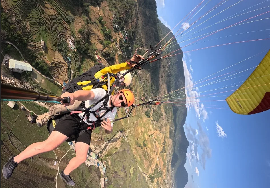 Tandem paraglide above the coastline